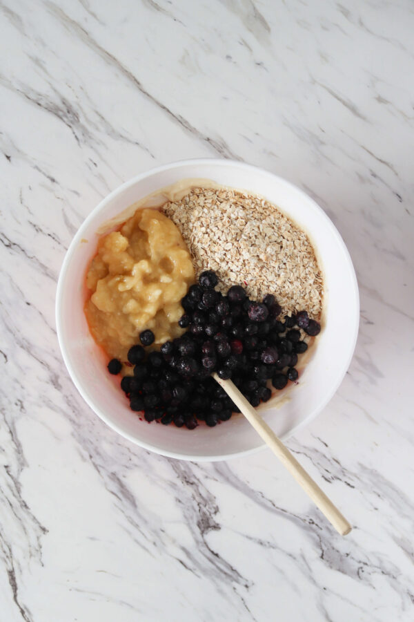 mixing in blueberries, oats and bananas to the batter